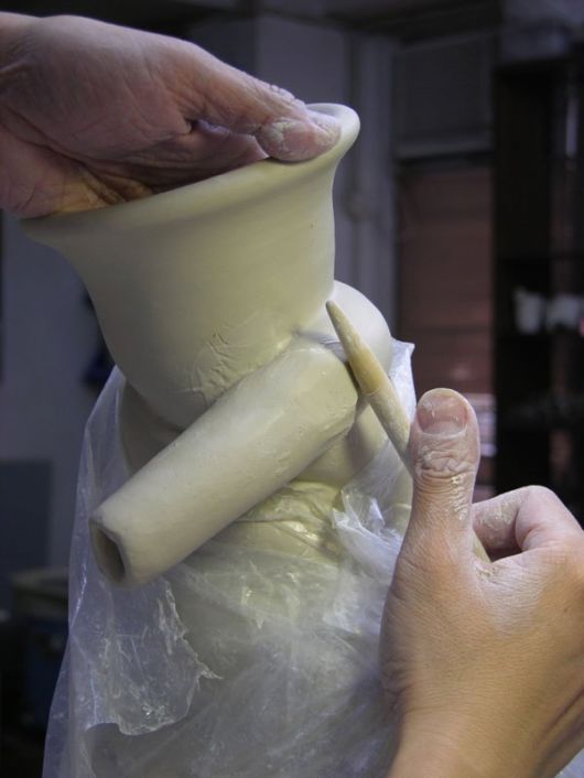 Tsang Sculpts a Dragon Strangling A Porcelain Vase